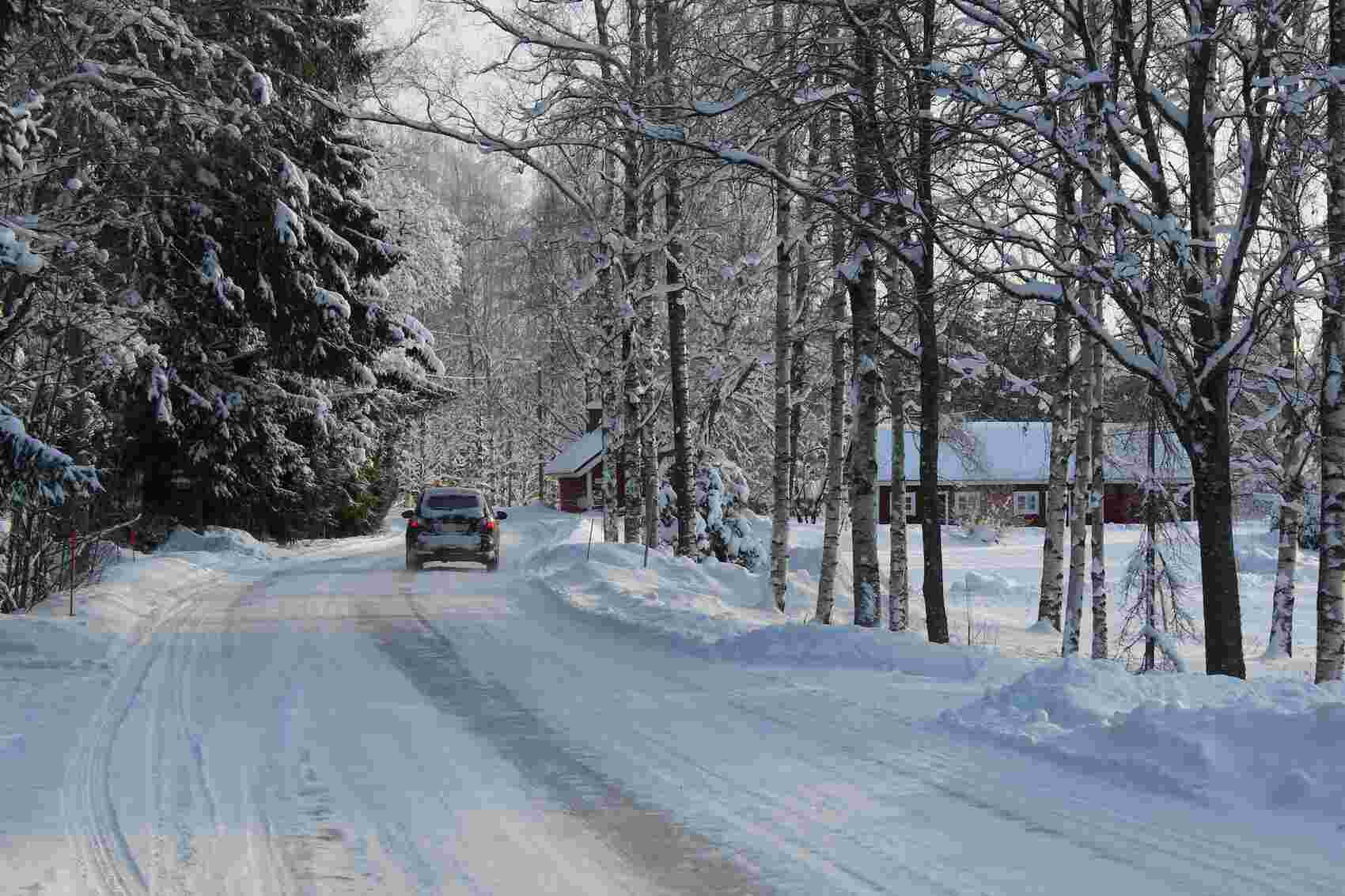 car driving on rural snowy road